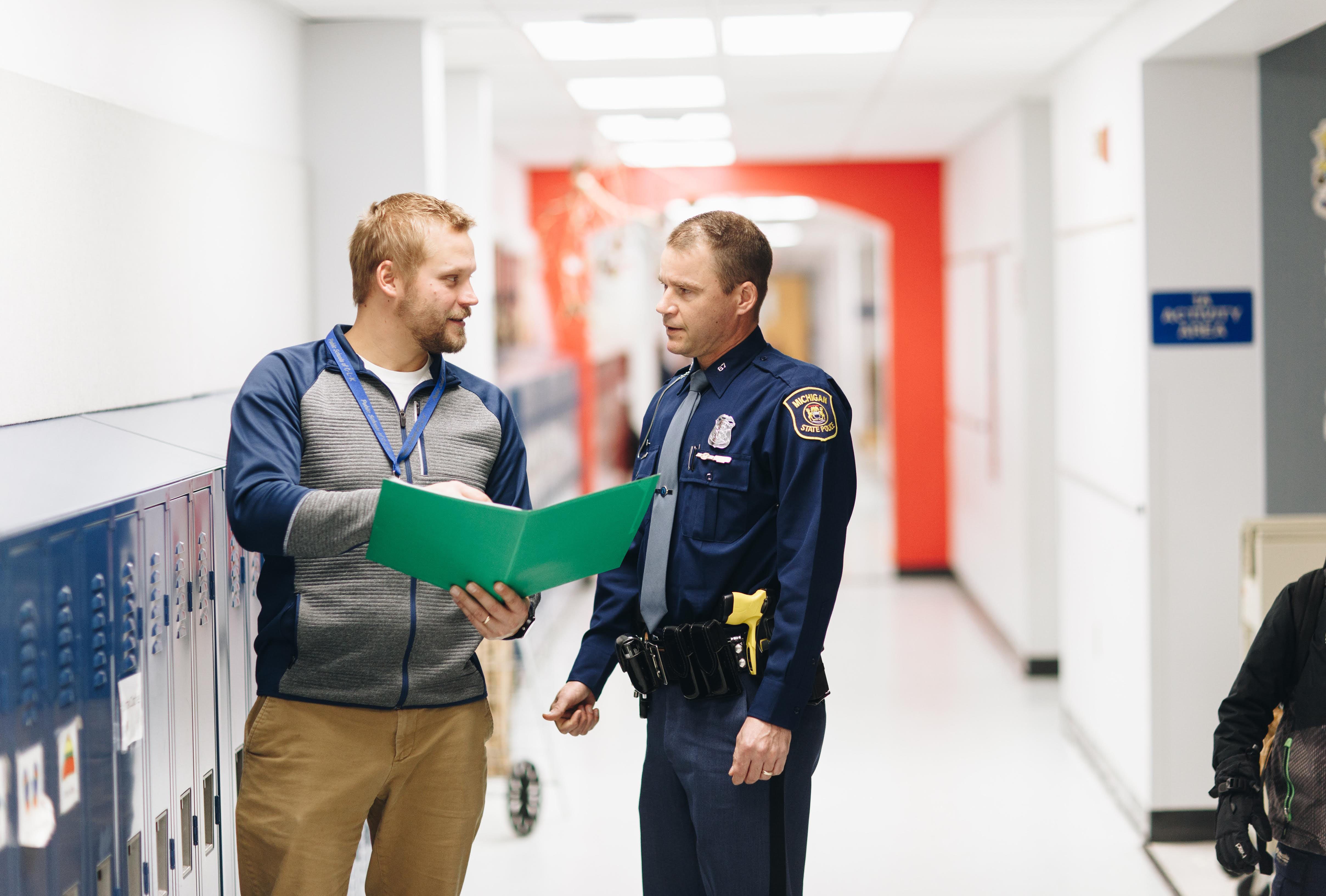 CLK Schools Darren Kinnunen talks with a Michigan State Police trooper