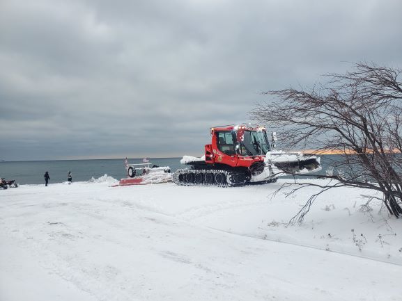 Snowmobile Trail Groomer above Lake Superior